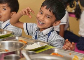 A CHIREC student delighting in his lunch break at school.