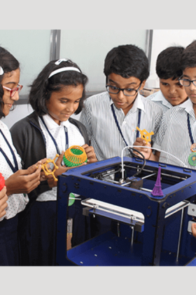 Students eagerly observing a 3D printing demonstration with excitement and curiosity