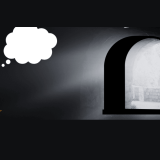 A student seated in a dimly lit room, lost in contemplation