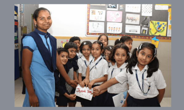 Learning to be humans CHIREC students expressing gratitude with a 'Thank You' card to the helping staff.