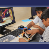 CHIREC students learning to use robotics kit while watching tutorial video